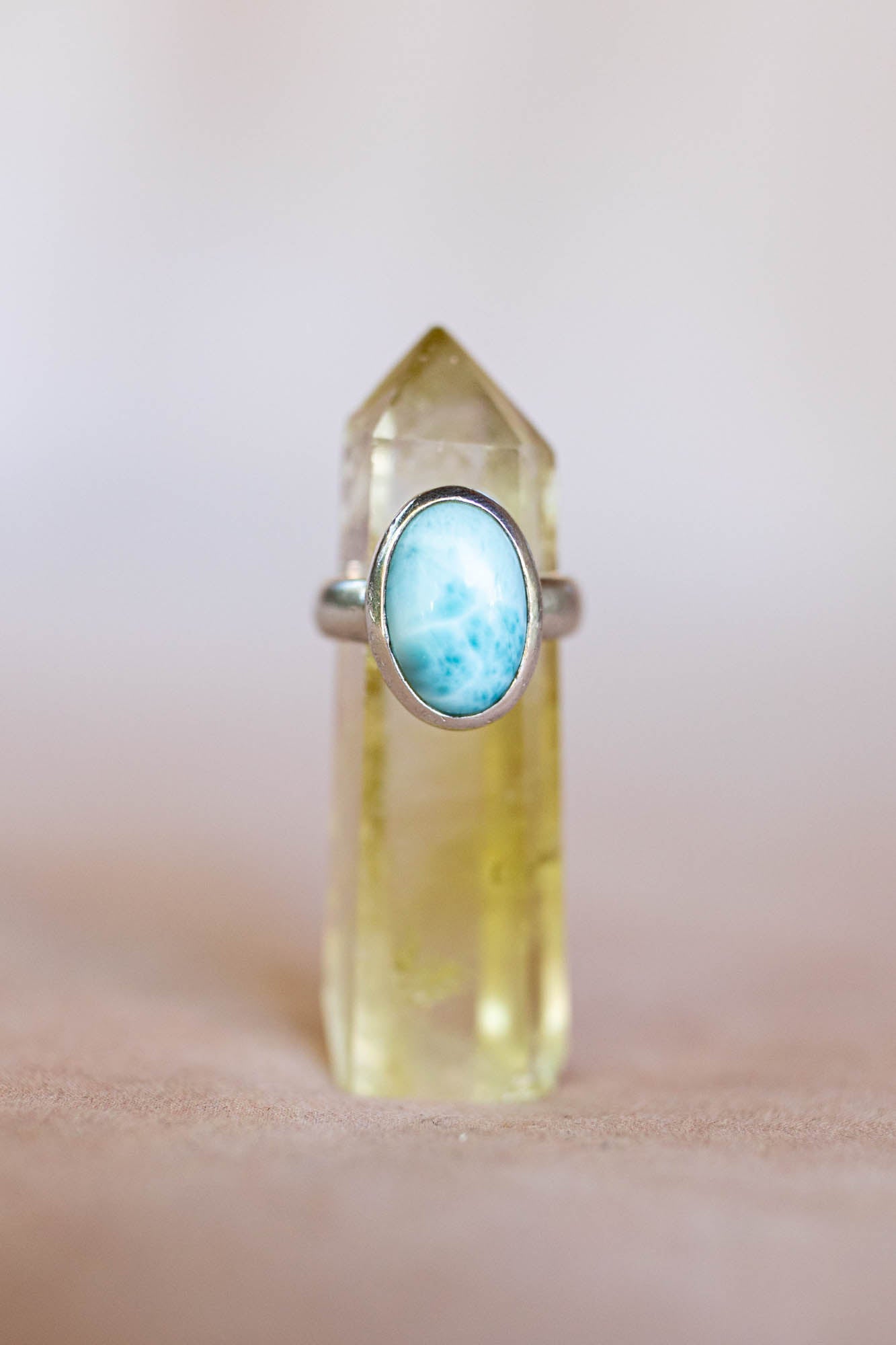 Ring with a blue gemstone on a clear crystal base